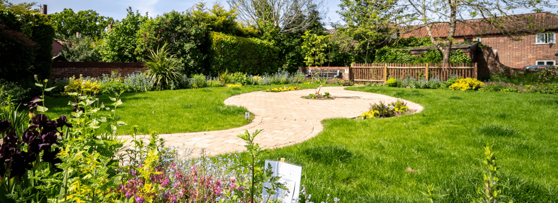 Landscaped gardens and winding pathways at Becket's Well in Wymondham